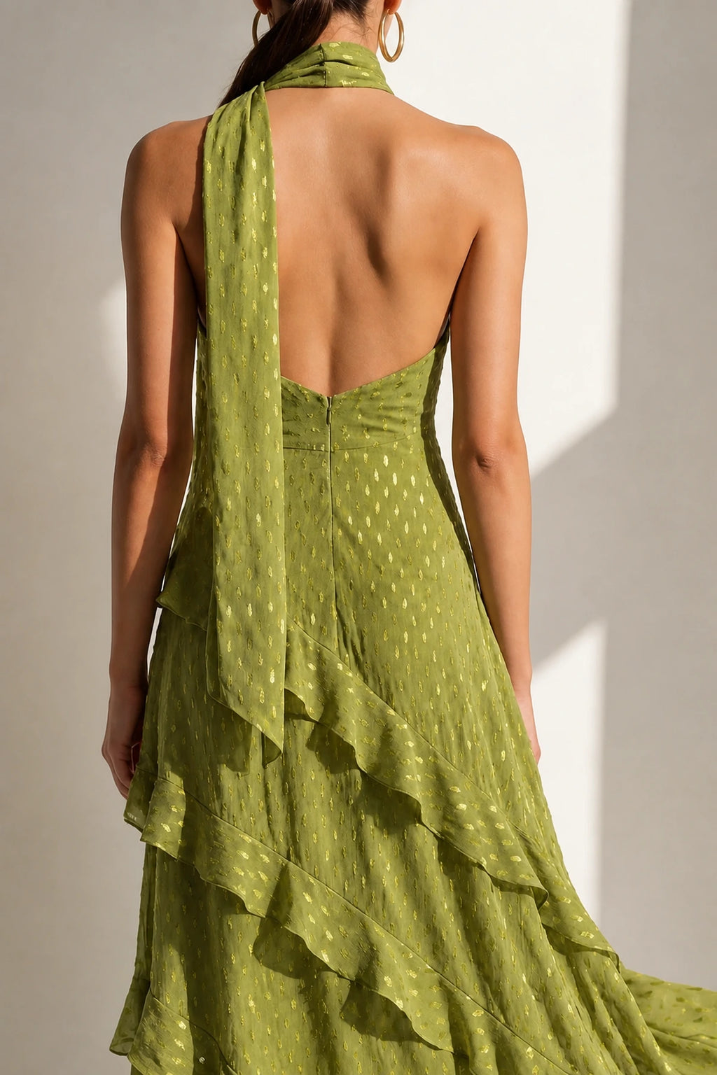 Back view of Graceprom olive green halter wedding guest dress with open back and layered ruffle skirt