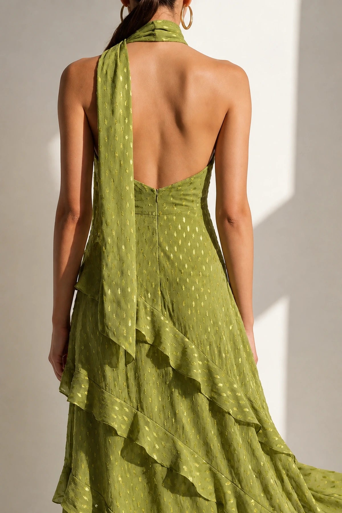 Back view of Graceprom olive green halter wedding guest dress with open back and layered ruffle skirt