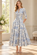 Ivory and blue floral A-line Mother of the Bride Dress with split neckline, three-quarter sleeves and tie waist