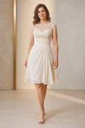 Vedress ivory A-line mother of the bride dress with illusion bateau neckline cap sleeves lace appliqué ruched waist and knee-length skirt front view