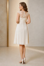 Vedress ivory mother of the bride dress with illusion lace back covered buttons cap sleeves ruched waist and knee-length A-line skirt back view