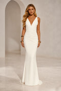 Ivory mermaid wedding guest dress with deep V-neckline, sleeveless wide straps, ruched waist and floor-length skirt