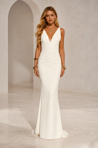 Ivory mermaid wedding guest dress with deep V-neckline, sleeveless wide straps, ruched waist and floor-length skirt