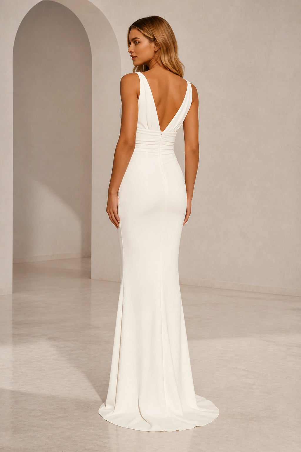 Back view of ivory wedding guest dress with deep V-back, center zipper and fitted floor-length mermaid silhouette