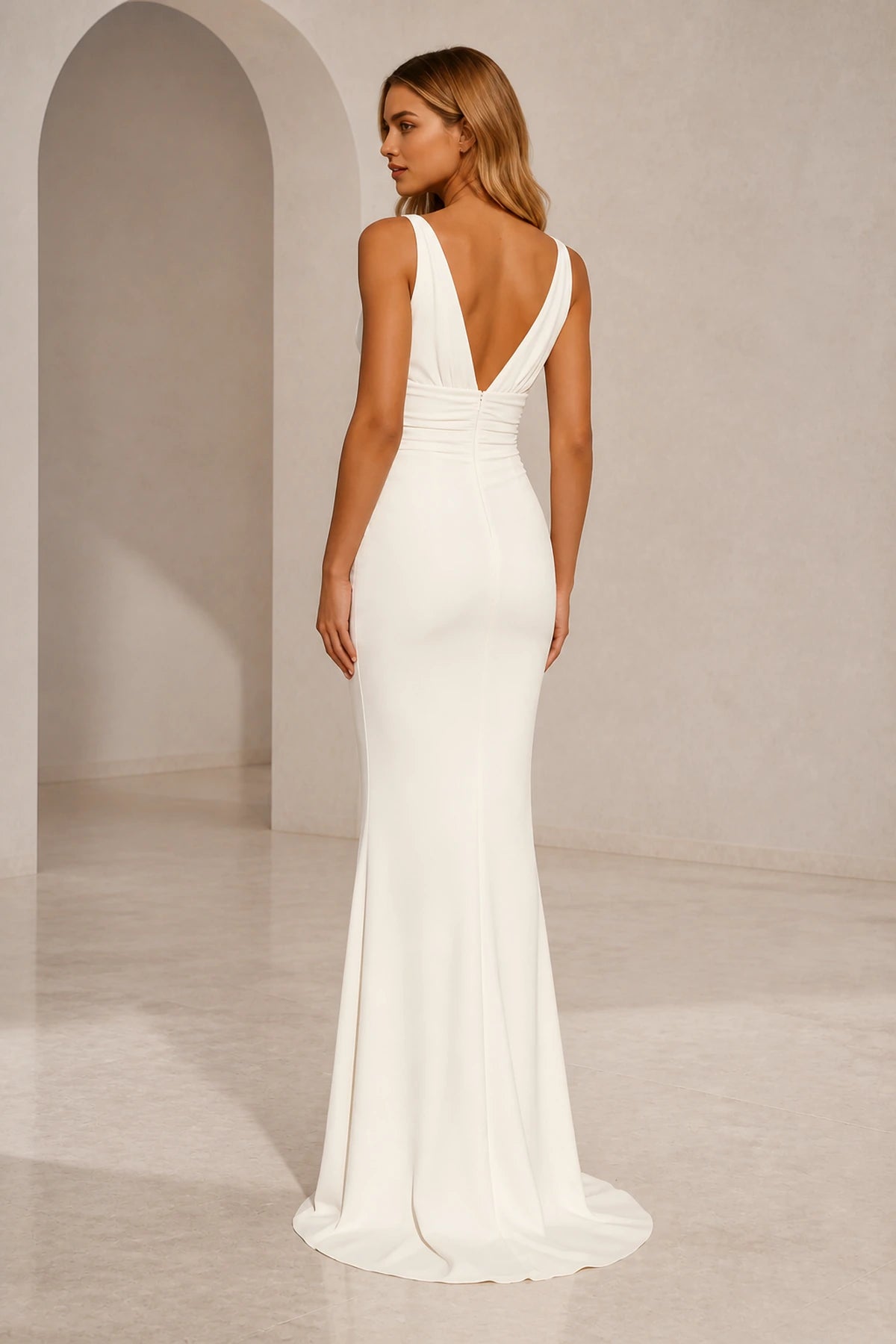 Back view of ivory wedding guest dress with deep V-back, center zipper and fitted floor-length mermaid silhouette