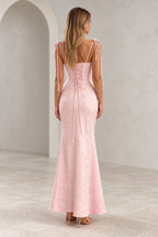 Back view of a pink Graceprom jacquard prom dress with bow-tie shoulder straps, a central lace-up bodice and a fitted mermaid skirt.