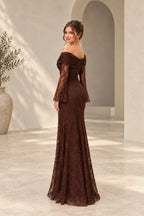 Back view of a chocolate brown lace wedding guest gown with an asymmetric draped neckline, sheer floral lace long sleeves, fitted waist, and flowing floor-length skirt.