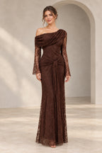 Chocolate brown floral lace wedding guest dress featuring an asymmetric off-the-shoulder neckline, sheer long sleeves, gathered waist, and floor-length sheath silhouette.