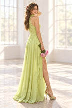 Rear three-quarter view of Graceprom light green prom dress with a high lace back, defined waistband and gathered floor length chiffon overskirt.