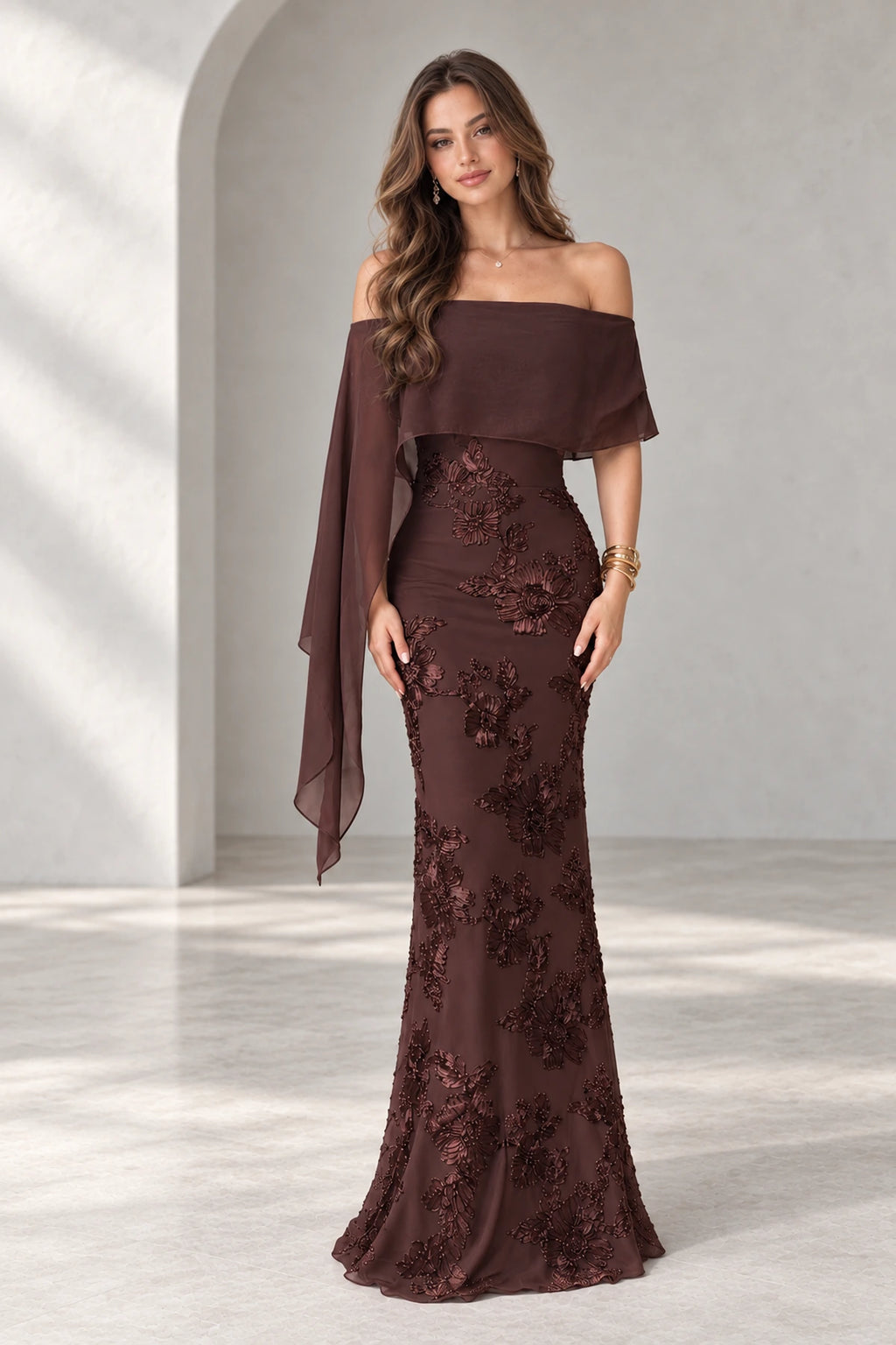 Graceprom brown lace and chiffon mermaid prom dress with floral beadwork, an off shoulder neckline and a long asymmetric cape panel.