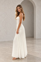 Back view of an ivory Graceprom wedding dress with a fitted lace bodice, slender shoulder straps and a flowing floor-length pleated skirt.