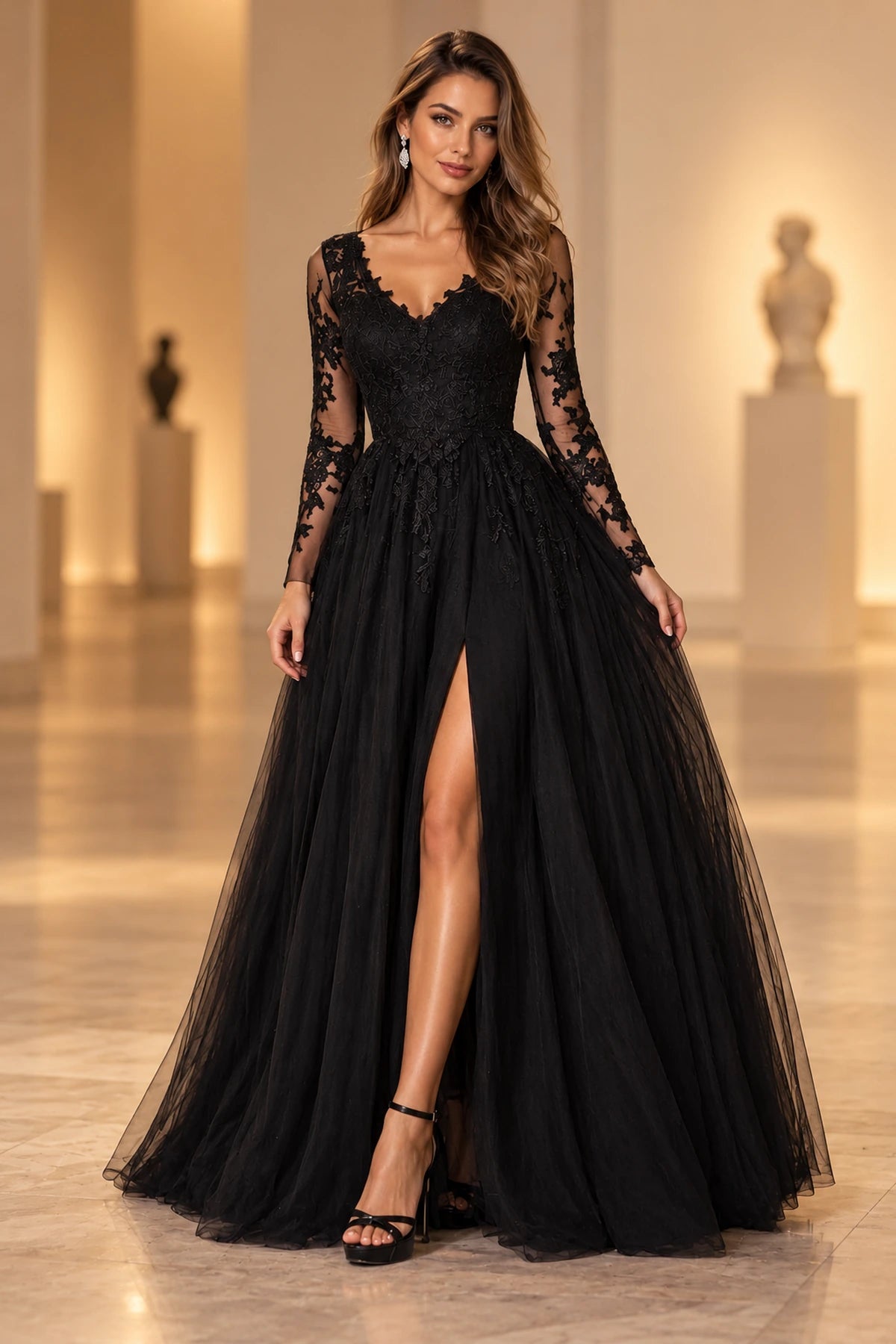Black A-line prom dress with a lace V-neck bodice, sheer floral long sleeves, flowing tulle skirt, and high front slit.