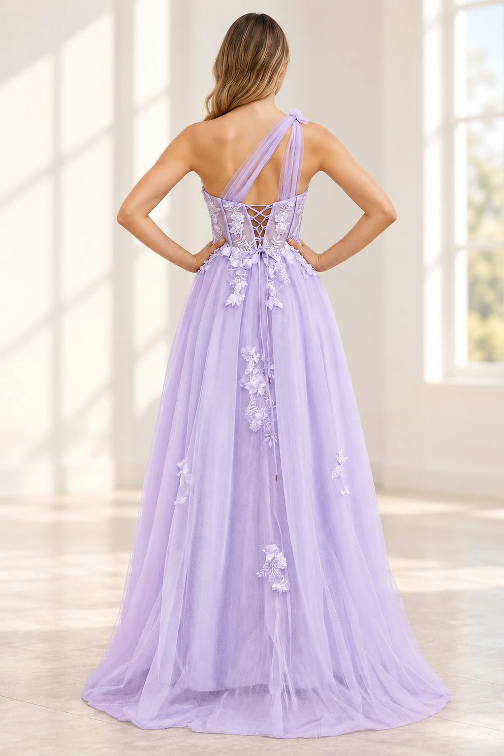 Back view of lavender floral A-line prom dress featuring an asymmetric one-shoulder strap, lace-up corset back and flowing tulle skirt