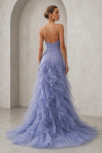 Back view of lavender strapless ruffle prom dress with zipper closure and layered skirt