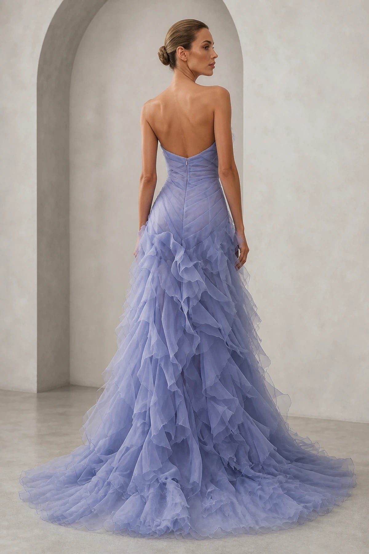 Back view of lavender strapless ruffle prom dress with zipper closure and layered skirt