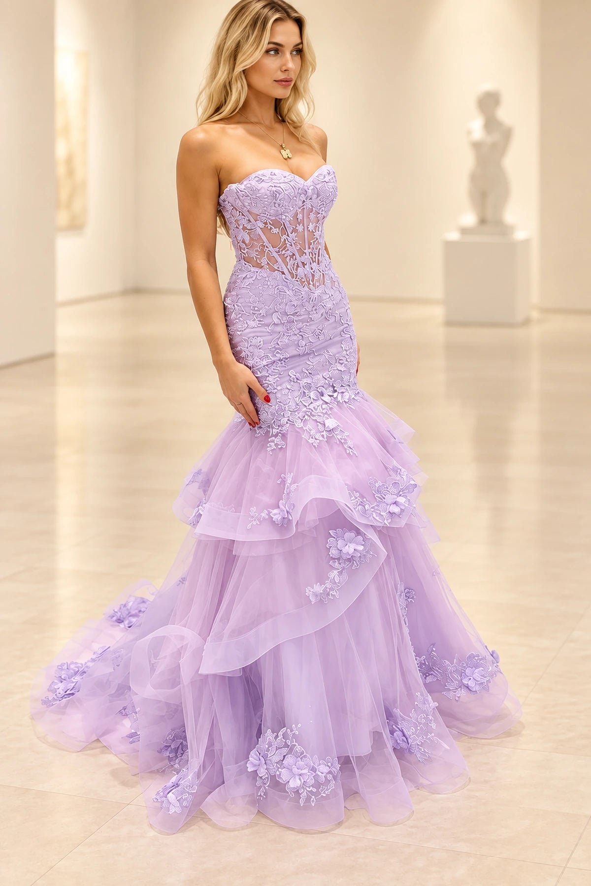 Lavender mermaid prom dress with a strapless sweetheart neckline, sheer corset-style bodice, floral lace appliques, and tiered floor-length tulle skirt.