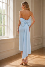 Back view of light blue wedding guest dress with oversized bow and draped panel