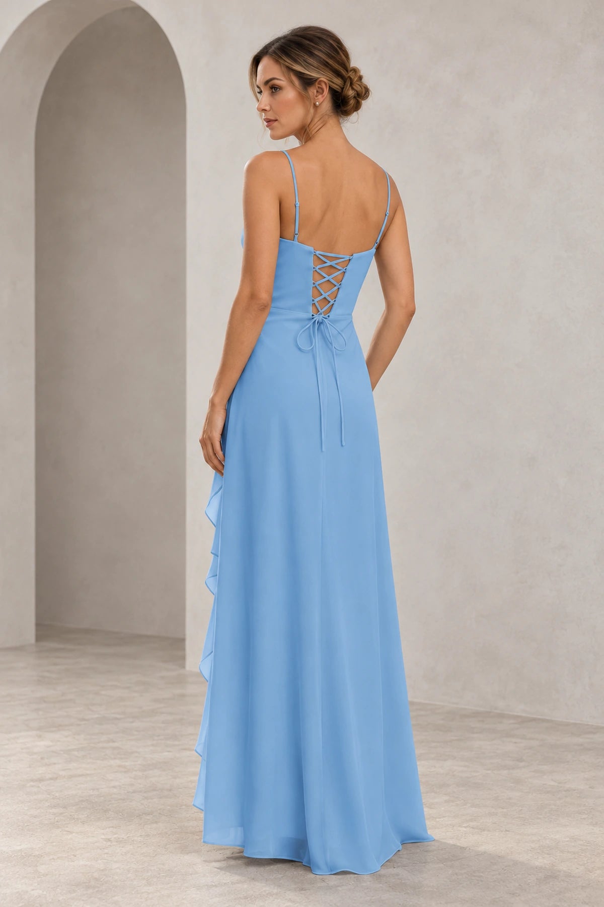 Back view of light blue chiffon-style A-line prom dress featuring adjustable spaghetti straps, a lace-up corset back and flowing floor-length skirt.