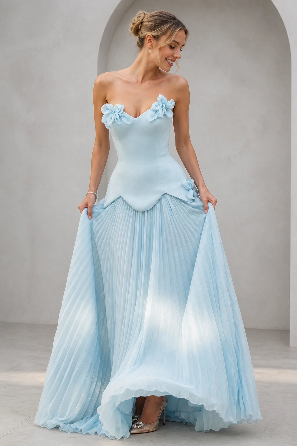 Light blue strapless sweetheart A-line bridesmaid dress with 3D floral accents and pleated floor-length skirt