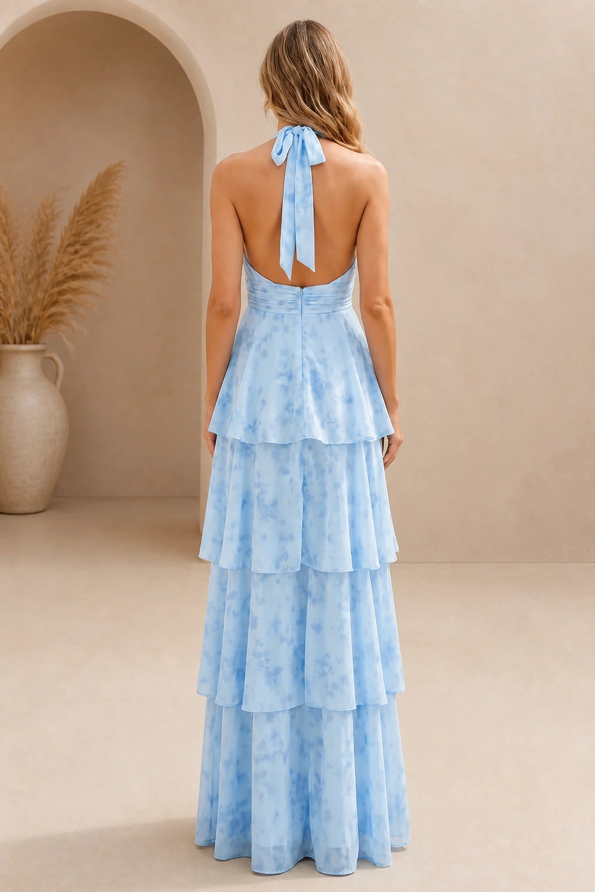 Back view of light blue bridesmaid dress with halter tie, open back and tiered floor-length A-line skirt