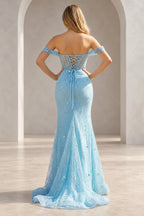 Light blue embellished prom dress with a low sheer back, crisscross lacing tied at the waist, fitted skirt, and flowing train.