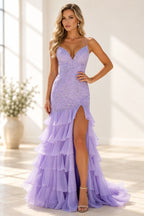 Lilac mermaid prom dress with a plunging V neckline, spaghetti straps, embellished bodice, tiered ruffles, and high front slit.