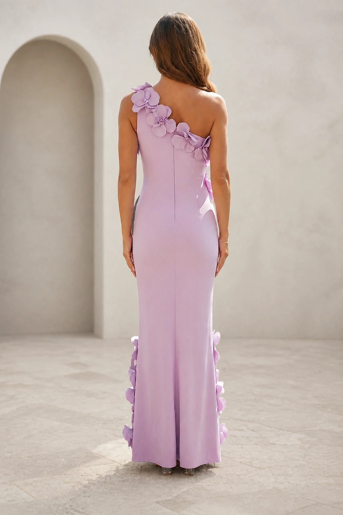 Back view of lilac wedding guest dress with asymmetric one-shoulder neckline, zipper back and floral floor-length skirt