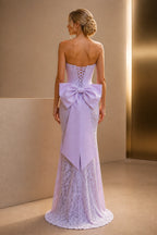 Lilac strapless wedding guest dress with corset bodice, lace skirt, front slit, and fitted mermaid silhouette