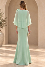 Back view of mint green floor-length mother of the bride dress with cape overlay center zipper and flared mermaid skirt