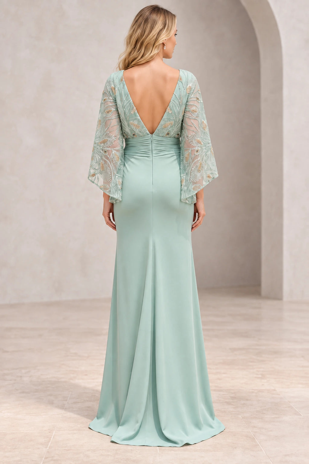 Back view of mint green mother of the bride dress with deep V open back embellished cape sleeves zipper and floor-length sheath skirt
