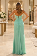 Mint green bridesmaid dress showing a low pleated back, narrow crisscross lacing, long waist ties, and a gathered floor-length skirt.