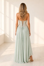 Mint green wedding guest dress with lace up back and flowing floor length skirt