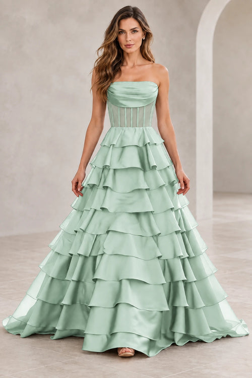 Mint green strapless A line prom dress with a draped straight neckline, sheer corset-style midriff, and floor-length tiered ruffle skirt.