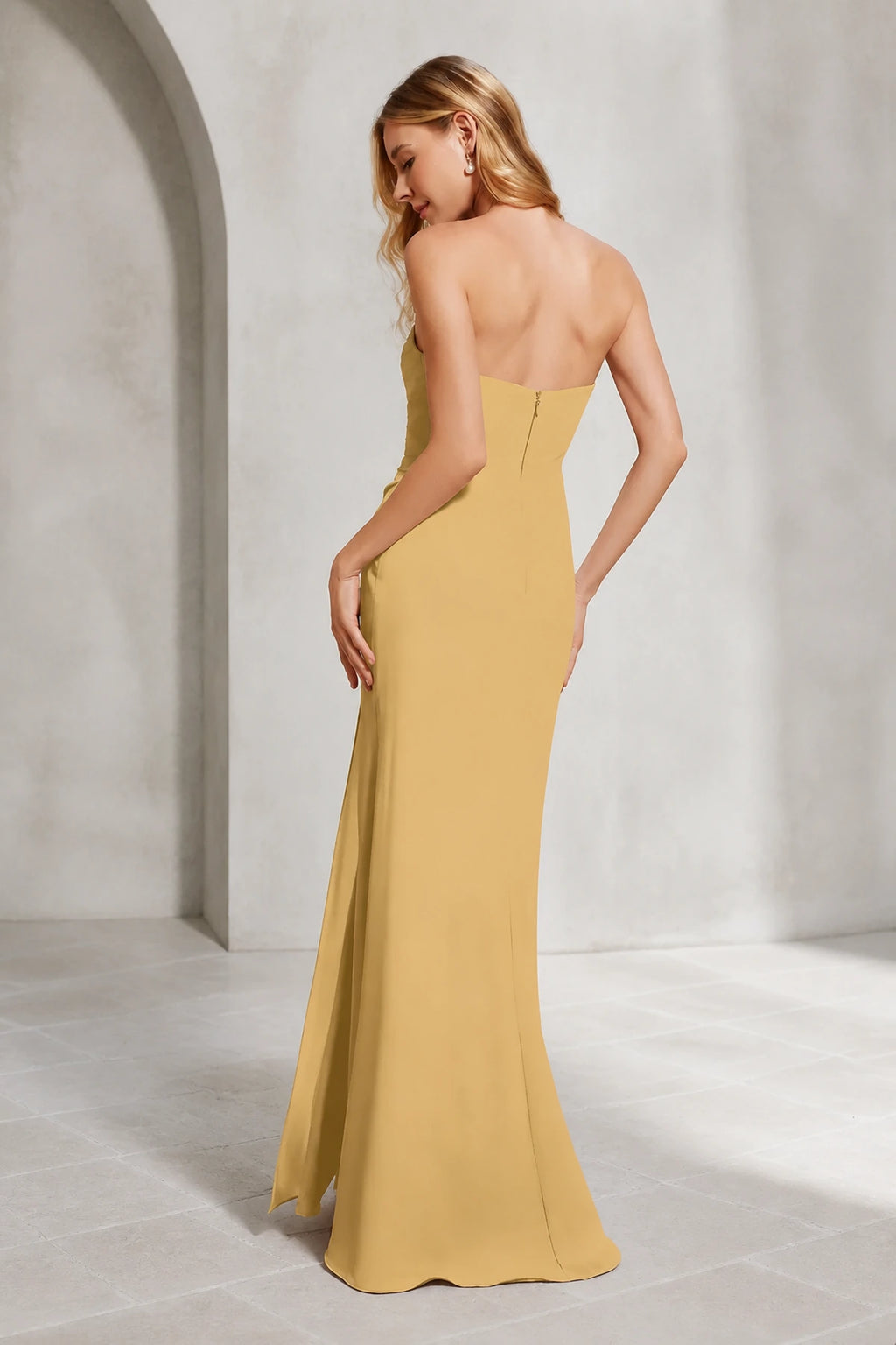 Mustard yellow bridesmaid dress with sweetheart neckline, strapless ruched bodice, side slit and floor-length sheath silhouette, front and back view