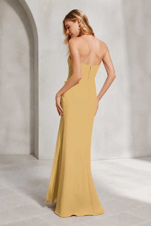 Mustard yellow bridesmaid dress with sweetheart neckline, strapless ruched bodice, side slit and floor-length sheath silhouette, front and back view