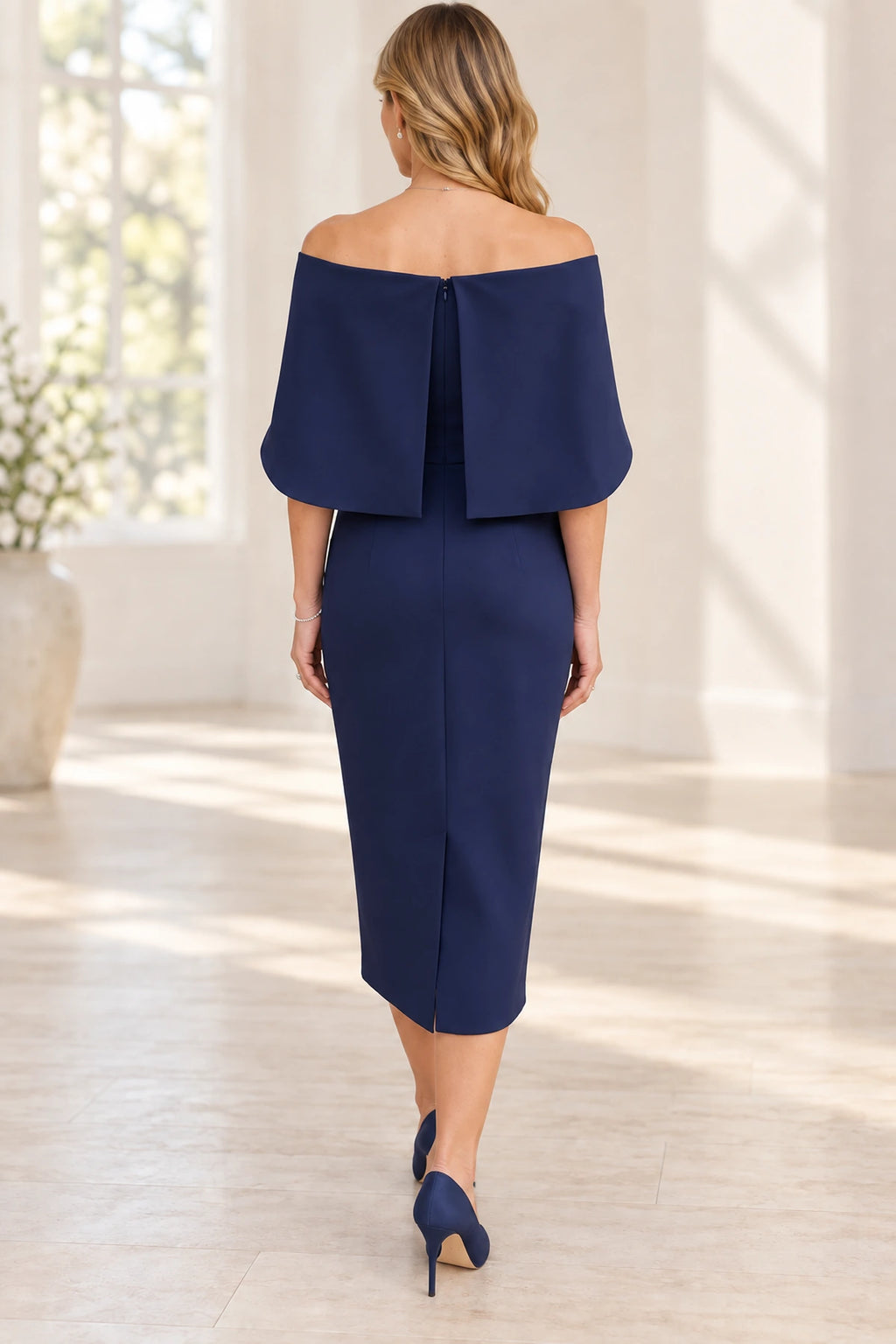 Back view of navy blue Mother of the Bride Dress with cape sleeves, center zipper and fitted midi skirt
