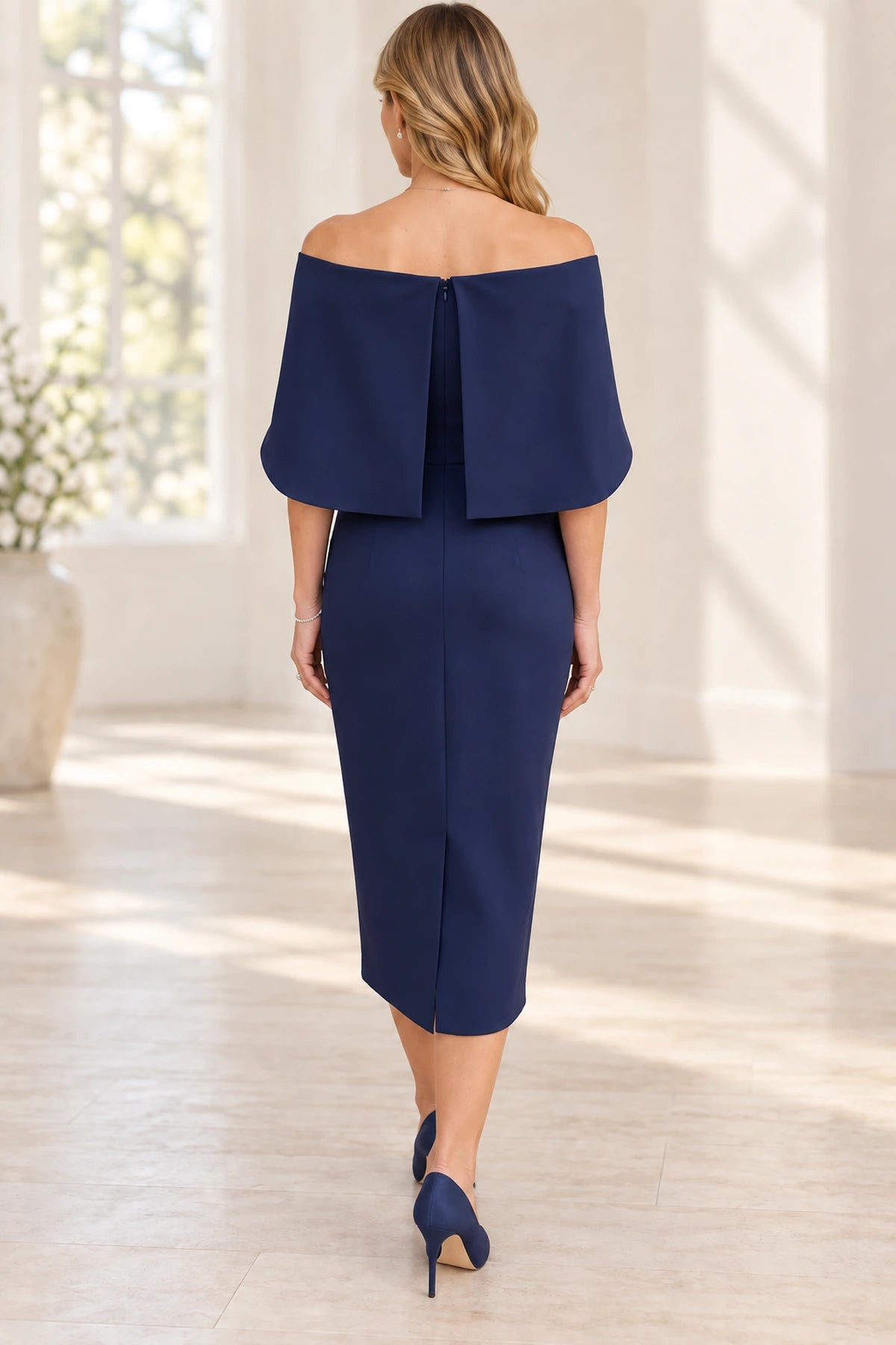 Back view of navy blue Mother of the Bride Dress with cape sleeves, center zipper and fitted midi skirt