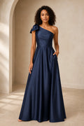 Navy blue one shoulder A-line prom dress with bow detail, fitted waist and floor-length skirt, front and back view