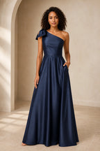 Navy blue one shoulder A-line prom dress with bow detail, fitted waist and floor-length skirt, front and back view