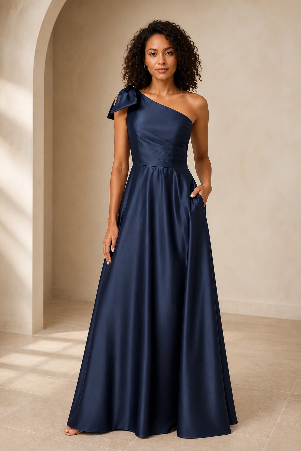 Navy blue one shoulder A-line prom dress with bow detail, fitted waist and floor-length skirt, front and back view
