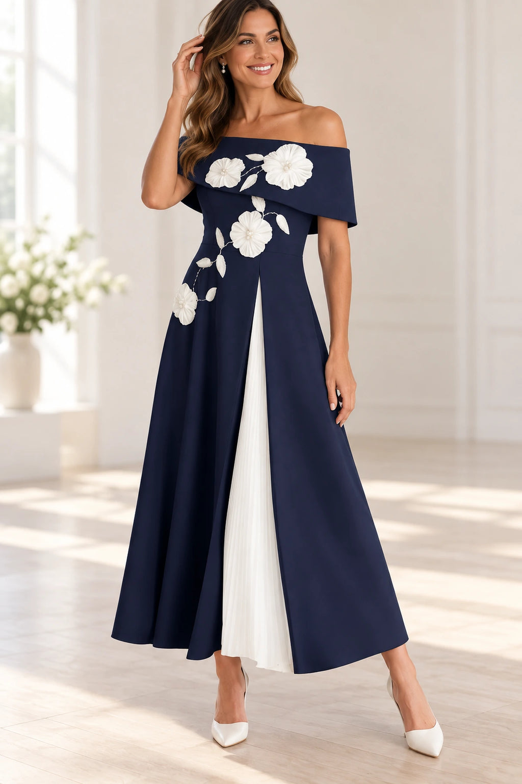 Navy Mother of the Bride Dress with off-shoulder neckline, white floral appliqués and contrasting pleated front panel
