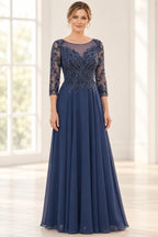 Navy blue mother of the bride dress with illusion neckline, beaded bodice, sheer three-quarter sleeves, and floor-length A-line skirt
