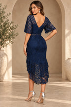 Navy blue lace wedding guest dress back view with V back flutter sleeves and layered ruffle hem