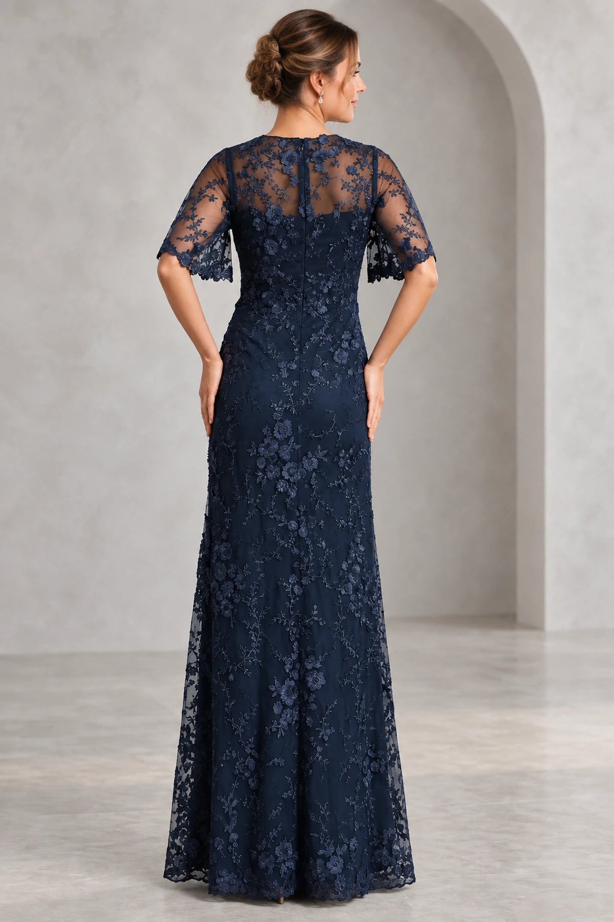 Navy lace Mother of the Bride Dress with sheer upper back flutter sleeves and fitted floor length silhouette