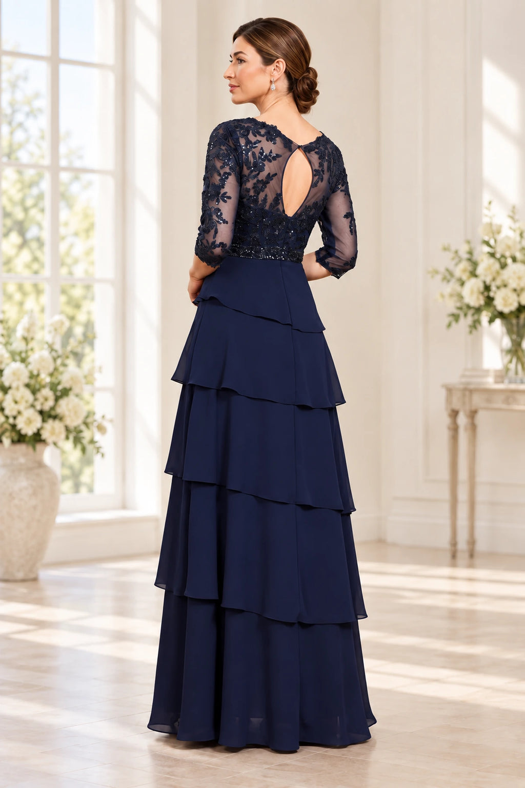 Back view of navy Mother of the Bride Dress with sheer lace keyhole back and layered floor-length skirt