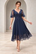 Navy mother of the bride dress with V neckline short illusion sleeves lace bodice and tea length A-line skirt