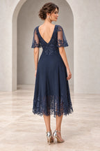Back view of navy mother of the bride dress with illusion lace sleeves V back and embroidered lace details