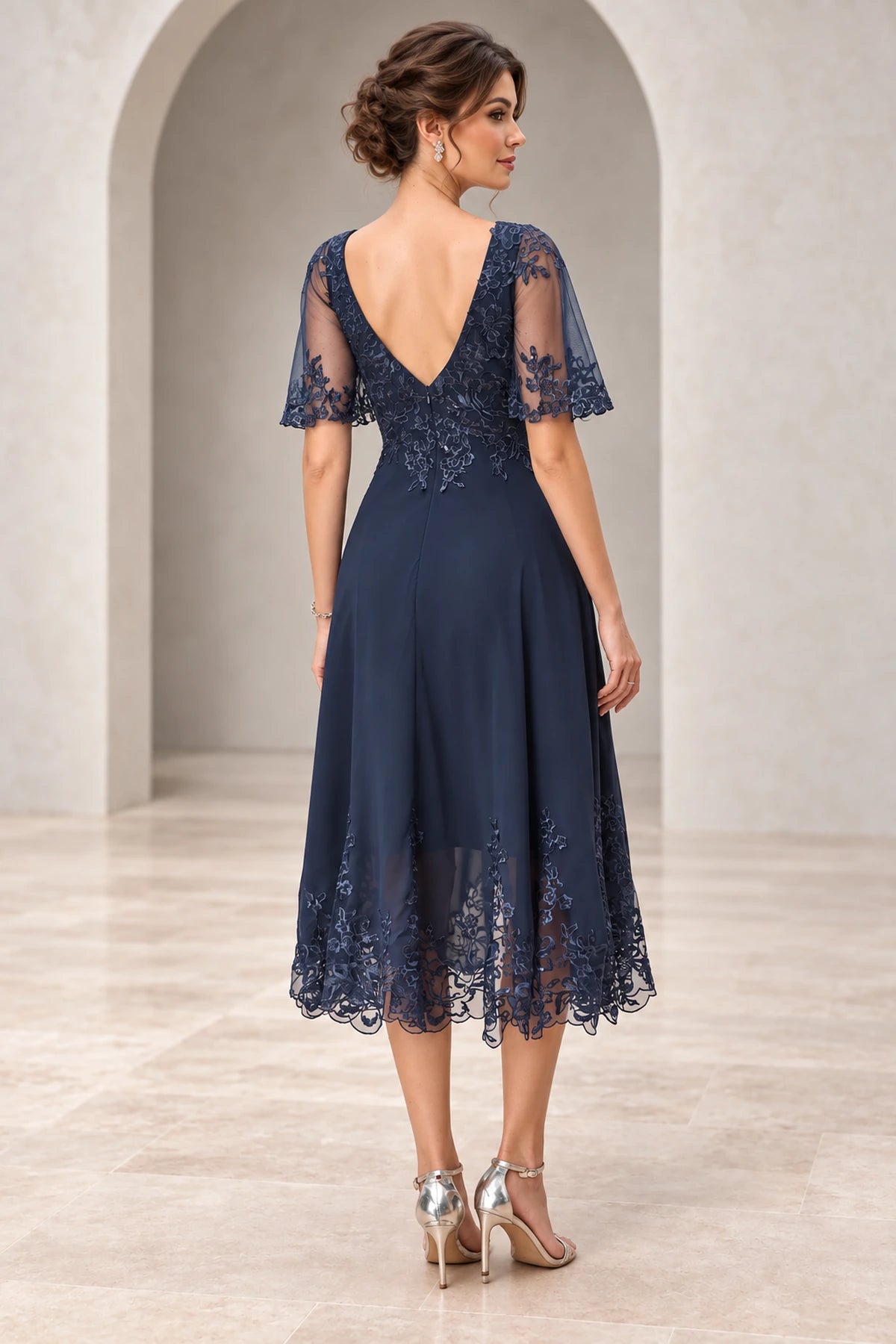 Back view of navy mother of the bride dress with illusion lace sleeves V back and embroidered lace details