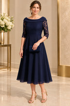 Navy mother of the bride dress with off shoulder neckline lace sleeves and tea length A line skirt