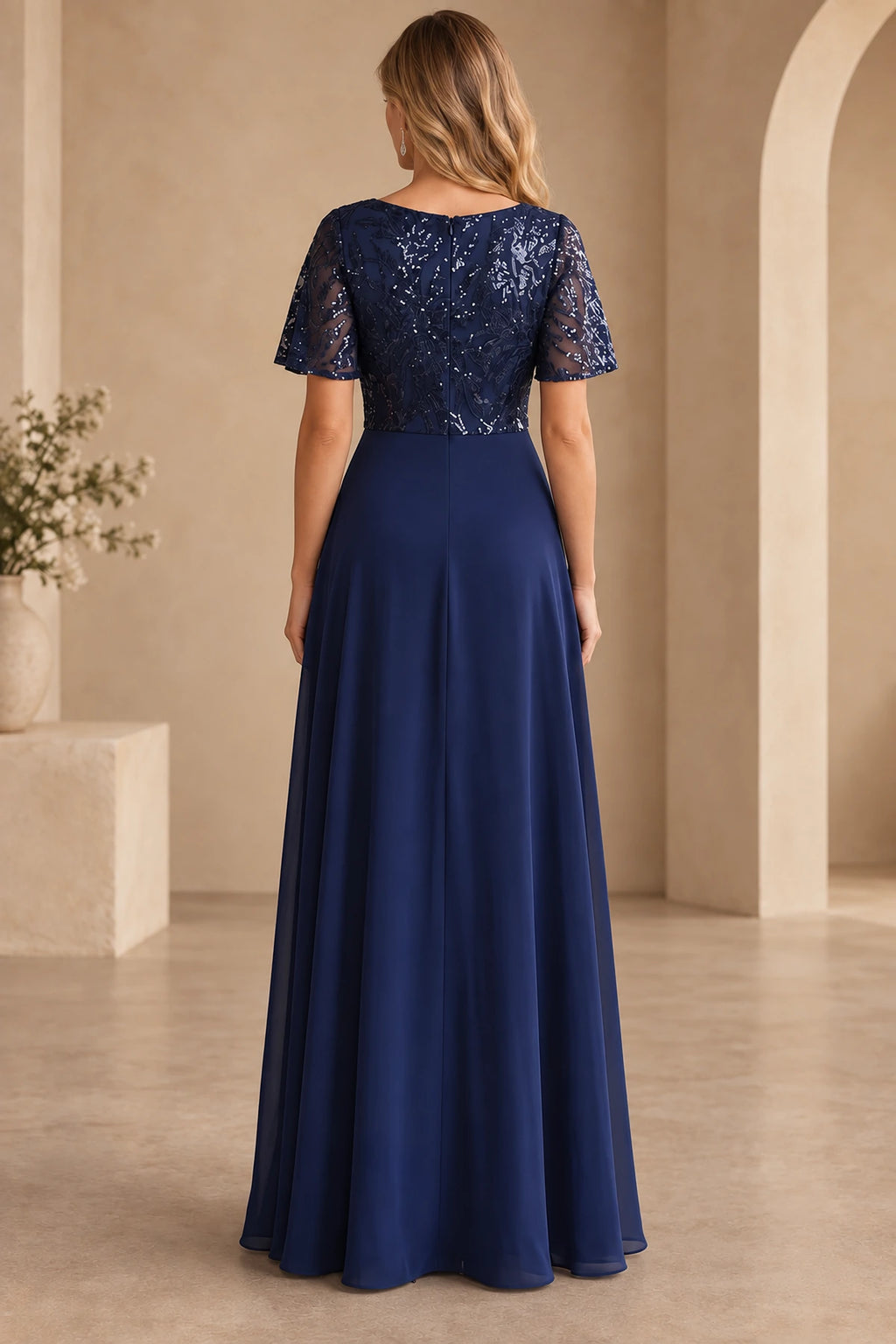 Back view of navy Mother of the Bride Dress with sequin bodice, short sleeves, center zipper and flowing A-line skirt